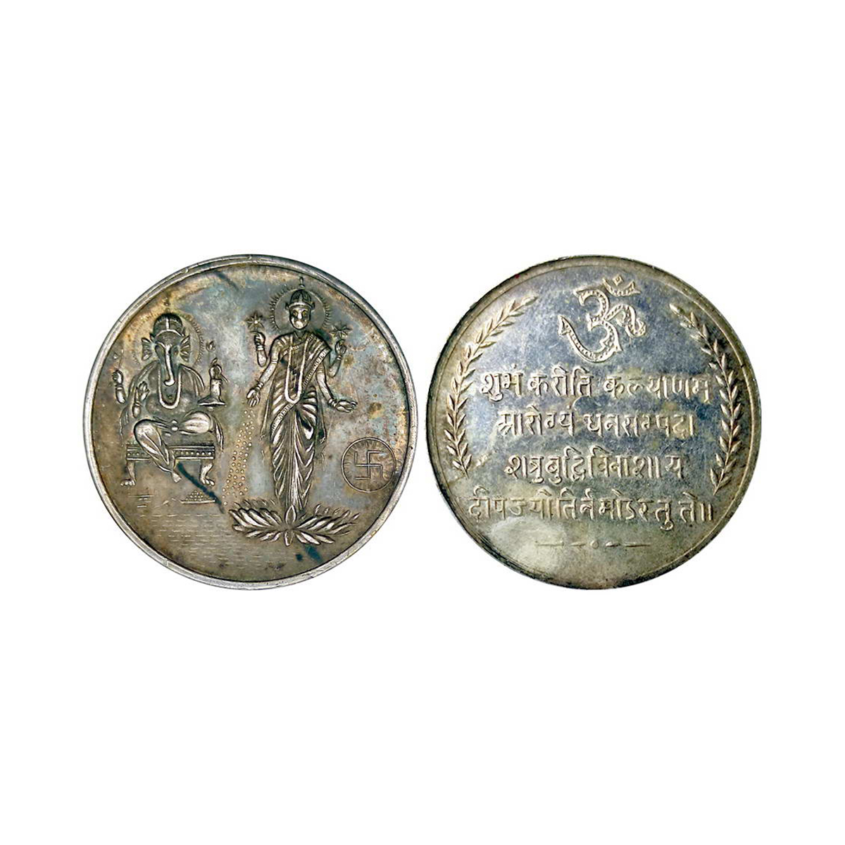 Ganesha, silver, 20g. Obv. Ganesha and Laxmi with swastika to right. Rev. OM within a deco